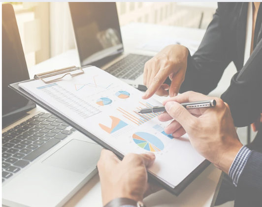 Business meeting with market analysis charts and graphs
